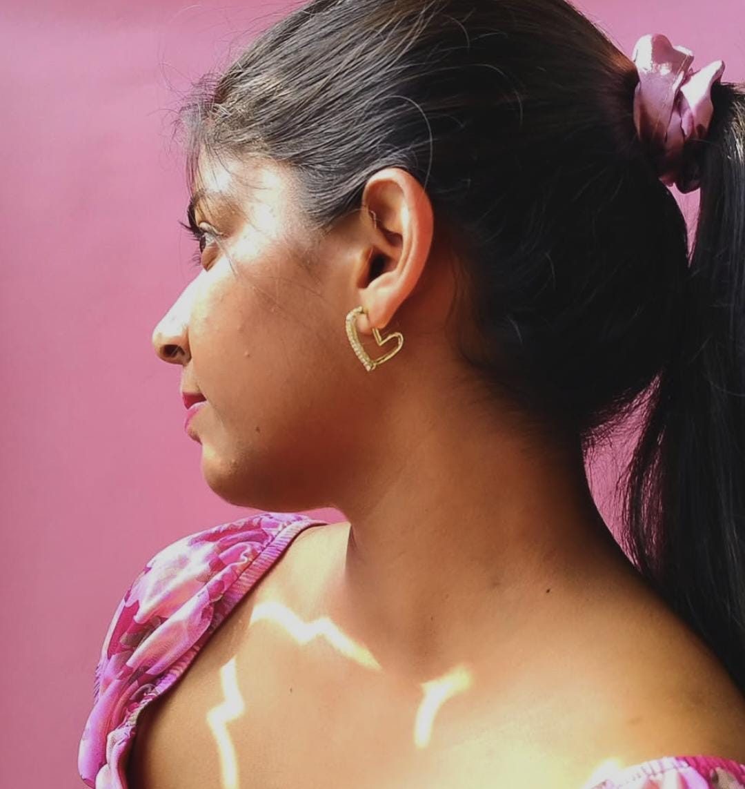 Heart earring, pink wall